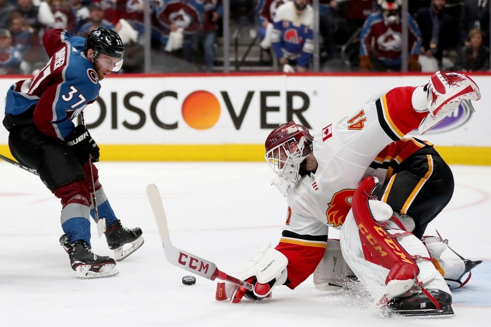 Goalie Mike Smith No. 41 of the Calgary Flames  saves a shot on goal by J.T. Compher No. 37 of the Colorado Avalanche in overtime during Game Four of the Western Conference First Round during the 2019 NHL Stanley Cup Playoffs at the Pepsi Center on Wednesday in Denver, Colorado. — AFP