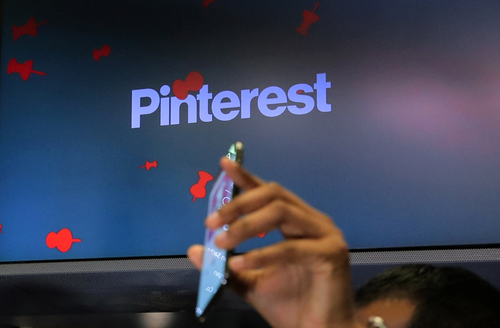 A guest hold up a phone during the Pinterest Inc. IPO on the floor of the New York Stock Exchange (NYSE) in New York, US, Thursday. — Reuters