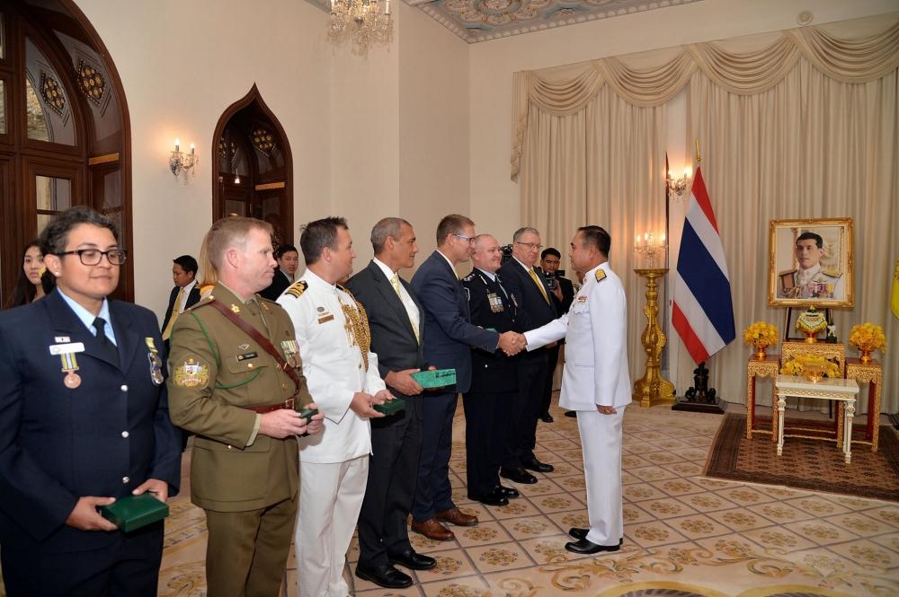 Richard Harris, Australian member of the Thai cave rescue team shakes hands with Thailand’s Prime Minister Prayuth Chan-ocha, next to Craig Challen after receiving the Member of the Most Admirable Order of the Direkgunabhorn award at the Government House in Bangkok, Thailand, on Friday. — Reuters