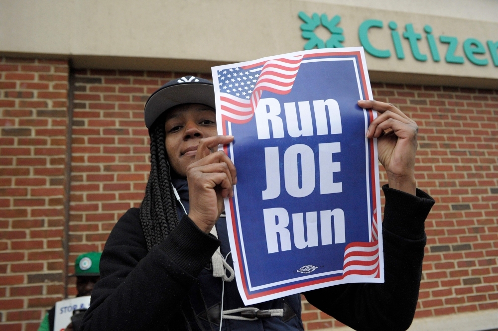 Jasmin Richardson holds a “Run Joe Run” sign after former US Vice President Joe Biden spoke at a rally organized by UFCW Union members to support Stop and Shop employees on strike throughout the region at the Stop and Shop in Dorchester, Massachusetts, on Thursday. — AFP