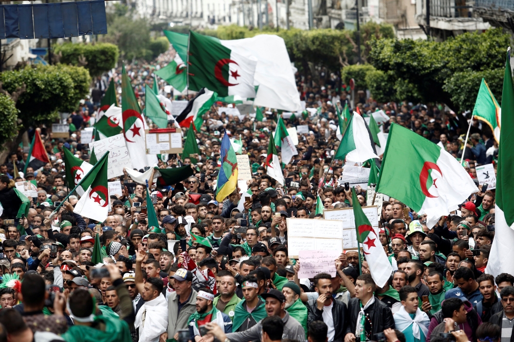 Demonstrators hold flags and banners as they return to the streets to press demands for wholesale democratic change well beyond former President Abdelaziz Bouteflika’s resignation, in Algiers, Algeria, on Friday. — Reuters