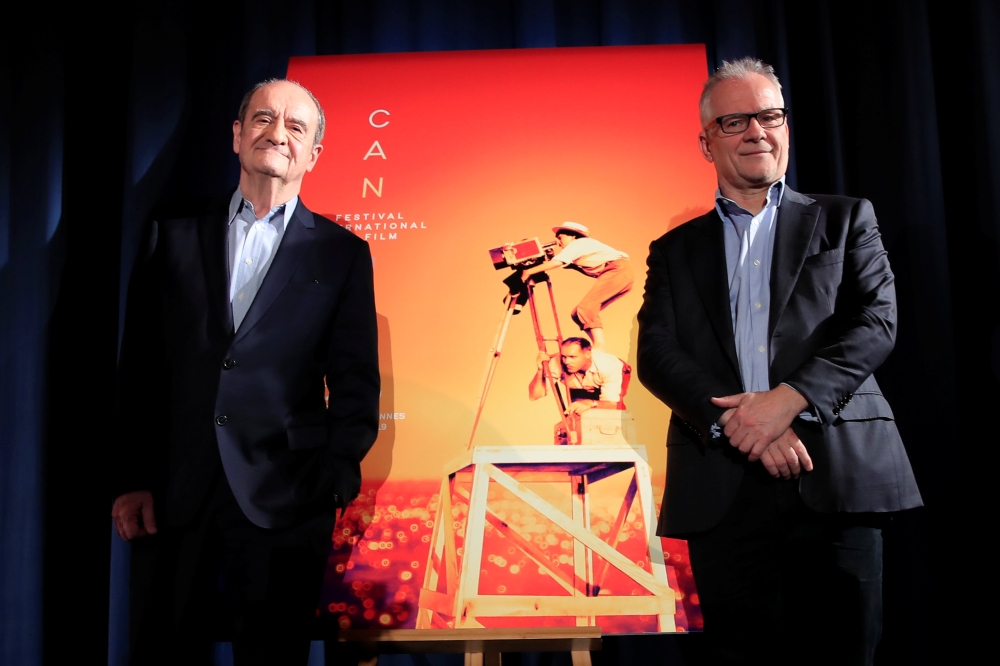 Cannes Film festival general delegate Thierry Fremaux and Cannes Film festival president Pierre Lescure pose next to the poster of the 72nd Cannes International Film Festival during a news conference to announce its official selection in Paris. — Reuters