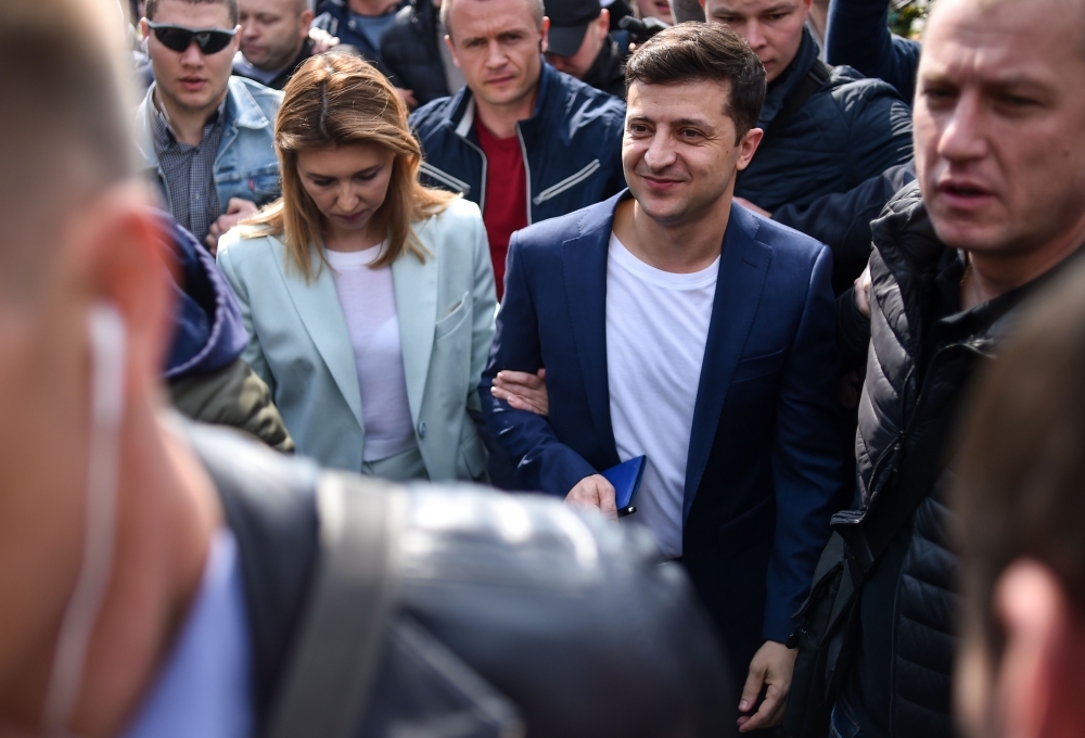 Bodyguards surround Ukrainian comedian and presidential candidate Volodymyr Zelensky and his wife Olena as they leave a polling station after casting their ballots during the second round of Ukraine's presidential election in Kiev, Sunday. — AFP
