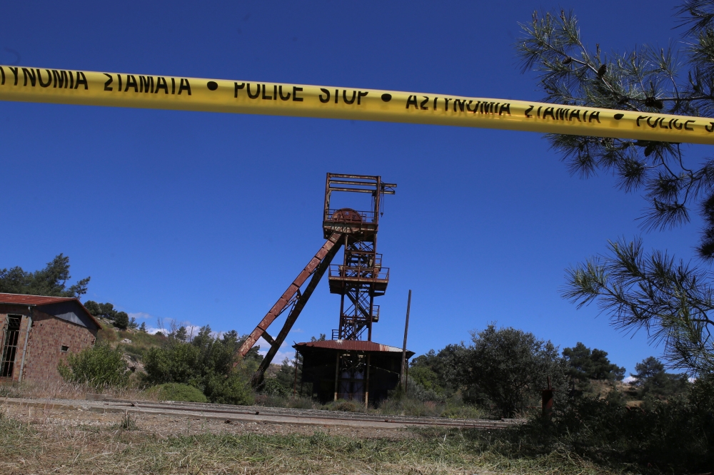 A police line tape secures the area around a mine where two women were found dead, near the village of Mitsero in Cyprus, on Monday. — Reuters