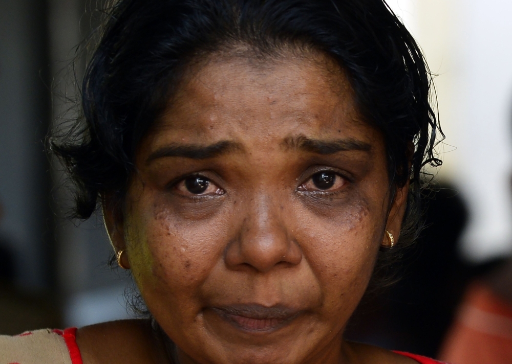 A Sri Lankan relative of a bomb blast victim weeps at a morgue in Colombo on Monday, as people gather hoping to identify loved ones missing or killed in the Easter Sunday bomb attacks on churches and hotels. — AFP
