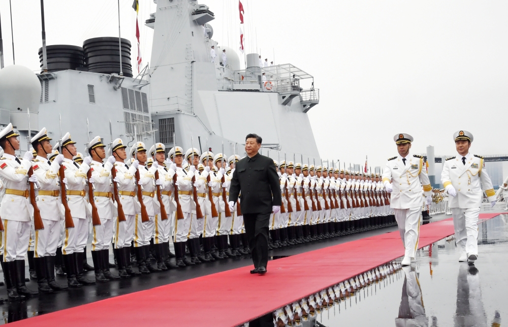 Chinese President Xi Jinping reviews the honor guards of the Chinese People’s Liberation (PLA) Navy before boarding the destroyer Xining for the naval parade celebrating the 70th founding anniversary of the Chinese People’s Liberation Army (PLA) Navy in Qingdao, Shandong province, China, on Tuesday. — Reuters