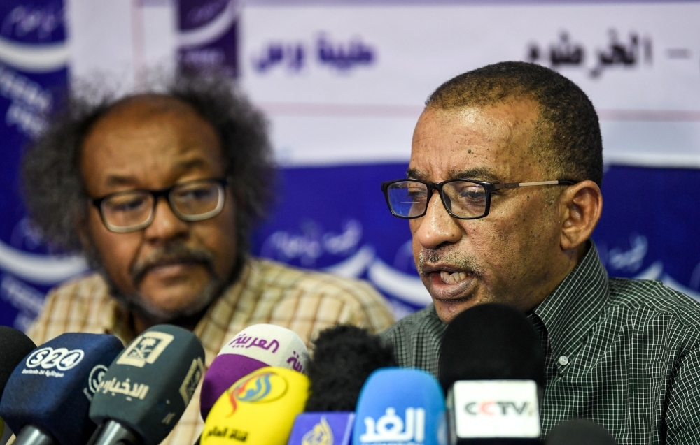 Sudanese civil society activists Muawia Shaddad, left, and Omar El-Digeir, right, two of the leaders from the protest movement led by the Alliance for Freedom and Change, give a press conference in the capital Khartoum on Wednesday. — AFP