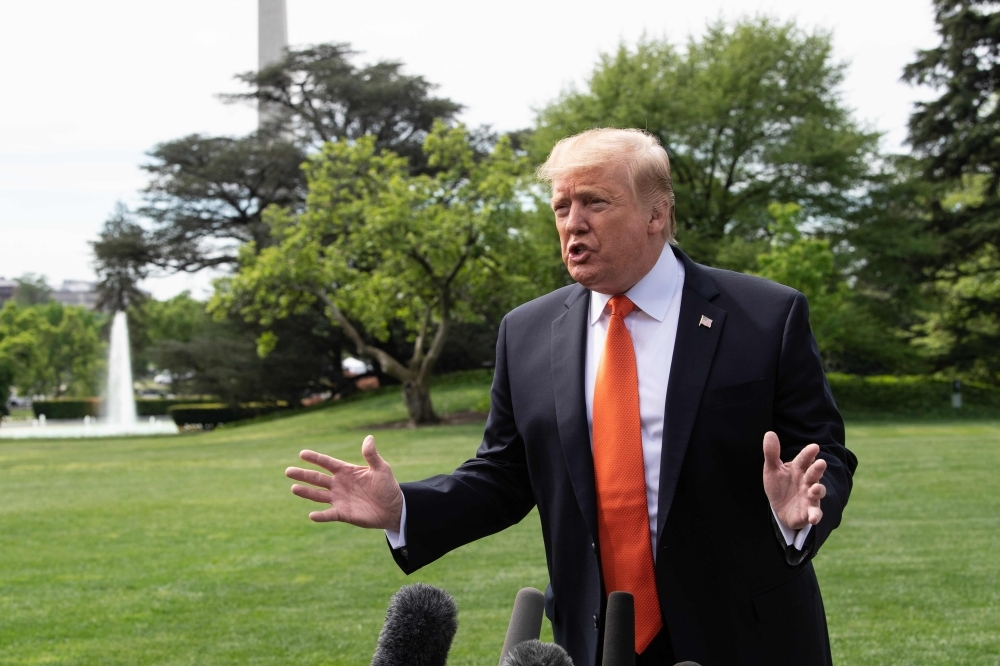 US President Donald Trump speaks to the press at the White House in Washington on Wednesday before departing for Atlanta, Georgia, to speak at the Rx Drug Abuse and Heroin Summit. — AFP