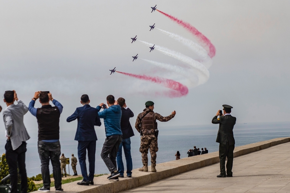 Turkish Air Force aerobatic team performs during an international service marking the 104th anniversary of the WWI battle of Gallipoli at the Turkish memorial Mehmetcik monument in the Gallipoli peninsula in Canakkale, Turkey, on Wednesday. — AFP