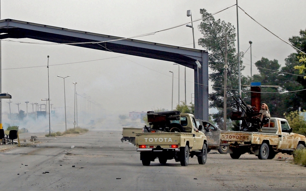 Vehicles belonging to Libyan fighters loyal to the Government of National Accord (GNA) are pictured during clashes with forces loyal to strongman Khalifa Haftar in Al-Hira region 70 km south of the capital Tripoli, Tuesday. — AFP photos 