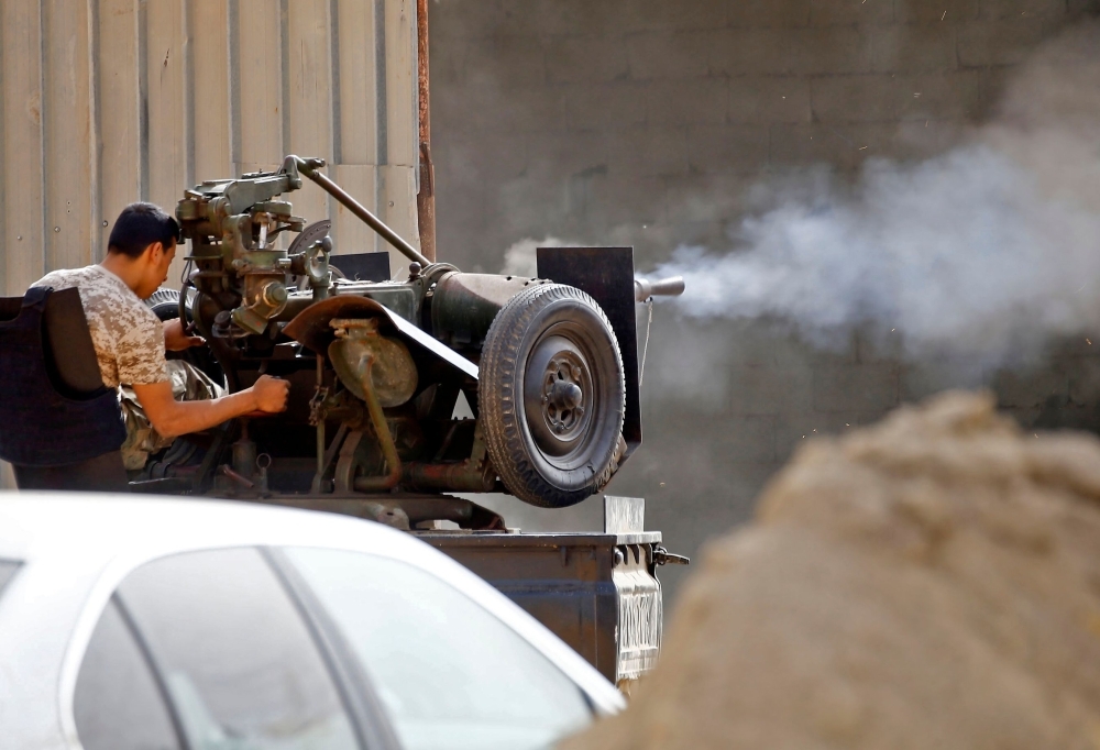 Vehicles belonging to Libyan fighters loyal to the Government of National Accord (GNA) are pictured during clashes with forces loyal to strongman Khalifa Haftar in Al-Hira region 70 km south of the capital Tripoli, Tuesday. — AFP photos 