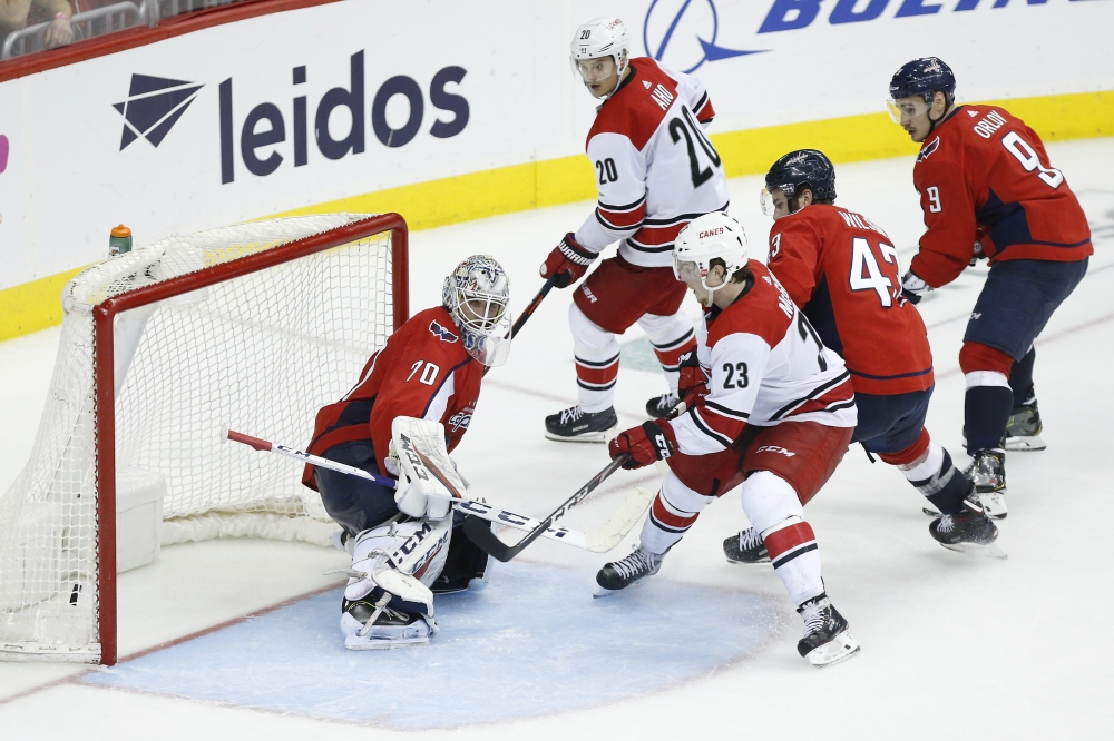 Carolina Hurricanes left wing Brock McGinn (23) scores the game-winning goal on Washington Capitals goaltender Braden Holtby (70) in the second overtime in game seven of the first round of the 2019 Stanley Cup Playoffs at Capital One Arena. — Reuters