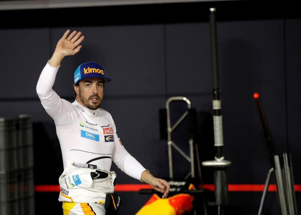 McLaren driver Fernando Alonso of Spain waves to spectators in the pit during the qualifying session at the Yas Marina racetrack in Abu Dhabi in this file photo. — Reuters