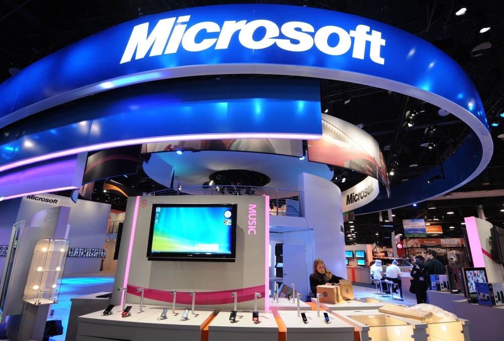In this file photo, workers set up products at the Microsoft display at the annual Consumer Electronics Show in Las Vegas, Nevada. Microsoft hit the trillion-dollar value mark on Thiursday, for the first time, becoming the third technology giant to reach the symbolic milestone. — AFP