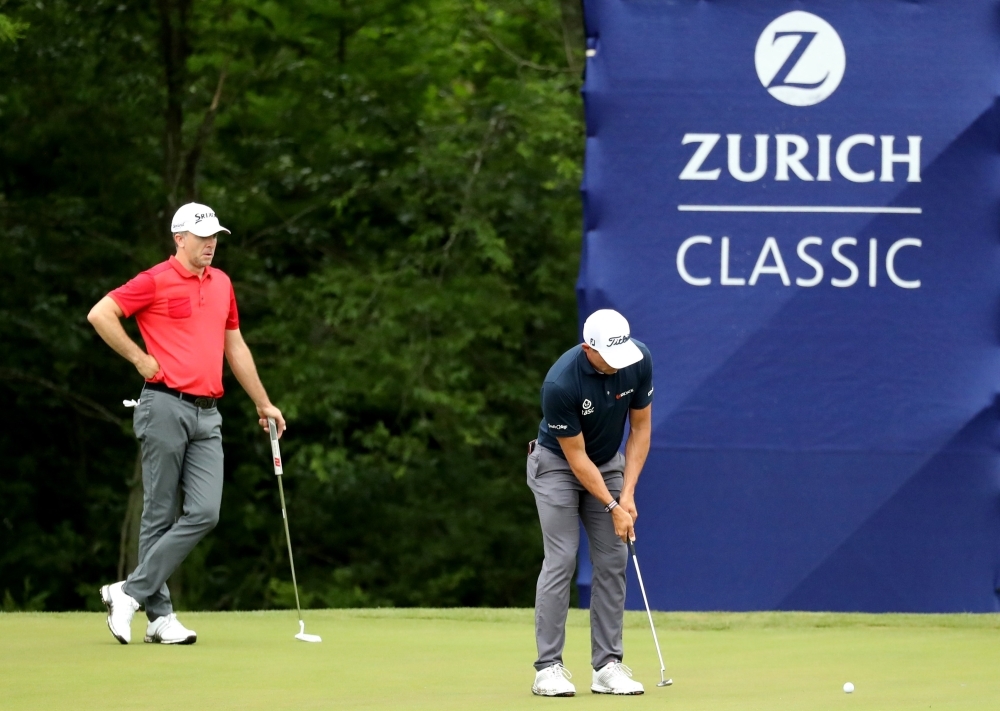 Scott Stallings of the United States putts as Martin Laird of Scotland looks on at the 15th green during the first round of the Zurich Classic at TPC Louisiana on Thursday in Avondale, Louisiana. — AFP