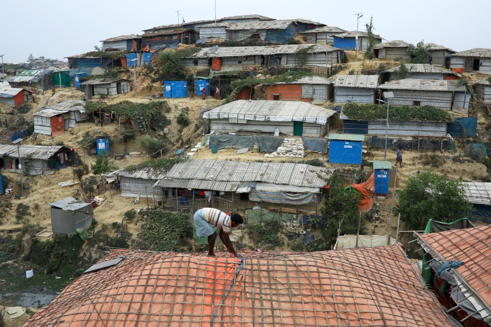 A Rohingya refugee repairs the roof of his shelter at the Balukhali refugee camp in Cox’s Bazar, Bangladesh, in this March 5, 2019 file photo. — Reuters