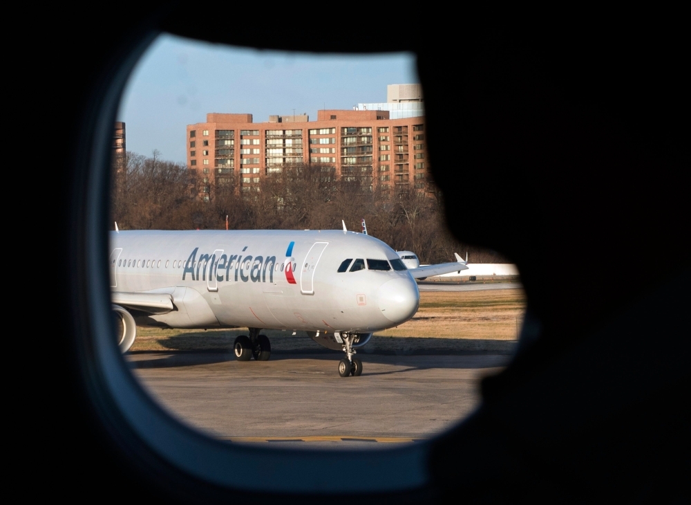 A man looks out his window at an American Airlines plane at Reagan National Airport in Arlington, Virginia, in this Feb. 24, 2017 file photo. — AFP