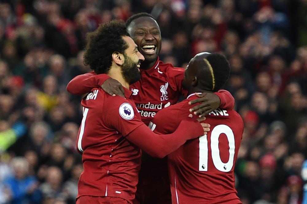 Liverpool's midfielder Naby Keita (2nd L) celebrates scoring during the English Premier League match against Huddersfield at Anfield in Liverpool Friday. — AFP