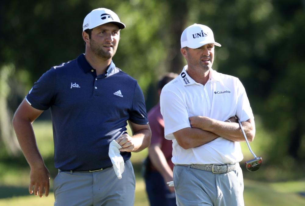 Jon Rahm of Spain and Ryan Palmer of the US talk on the 15th hole during the third round of the Zurich Classic at TPC Louisiana in Avondale, Louisiana, Saturday. — AFP 