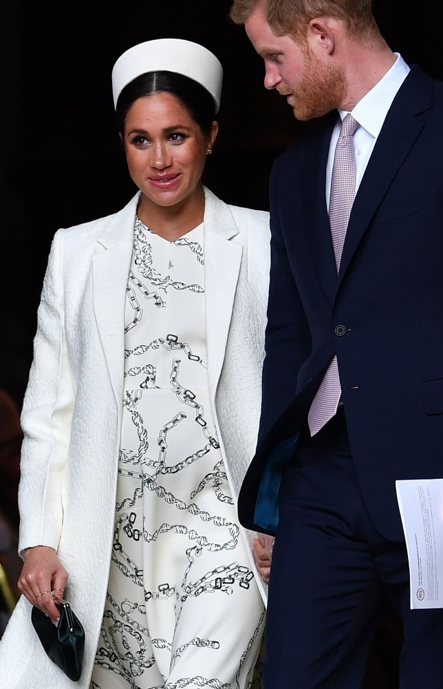 Britain's Prince Harry, Duke of Sussex (R) and Meghan, Duchess of Sussex