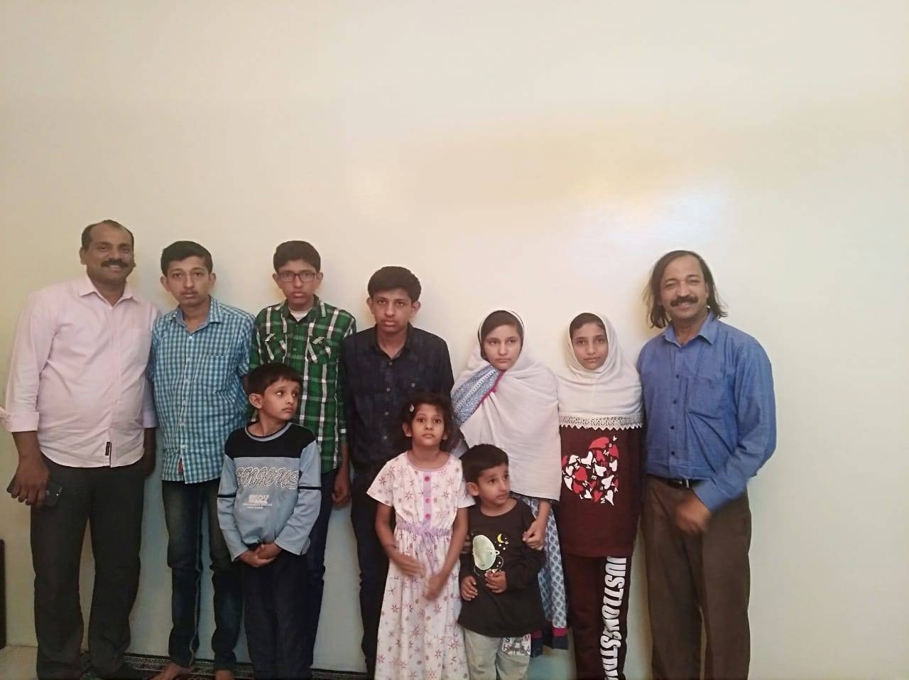 Social worker Shihab Kottukad, right, with the orphaned children before their departure to Canada.