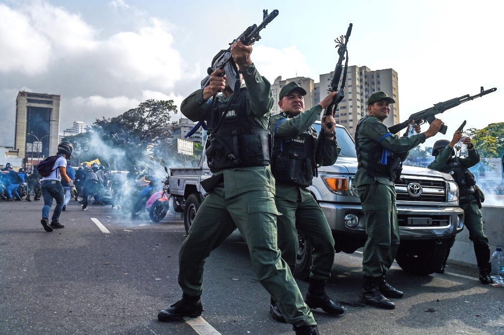 Opposition demonstrators clash with soldiers loyal to Venezuelan President Nicolas Maduro after troops joined opposition leader Juan Guaido in his campaign to oust Maduro’s government, in the surroundings of La Carlota military base in Caracas, on Tuesday. — AFP