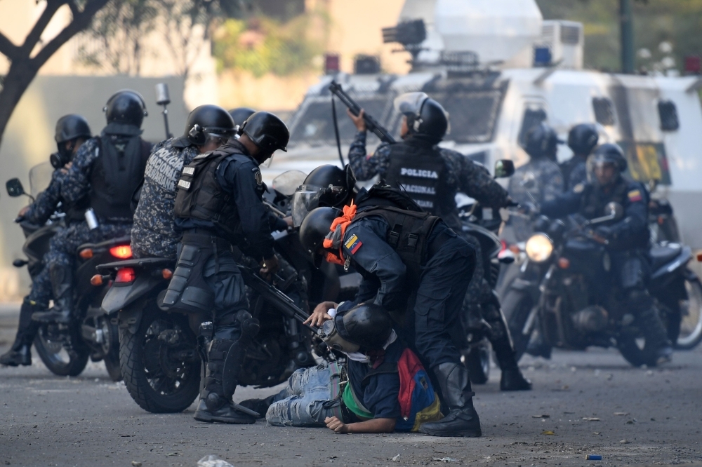 An anti-government protester is detained by security forces during clashes with security forces in Caracas on the commemoration of May Day on Wednesday, after a day of violent clashes on the streets of the capital spurred by Venezuela’s opposition leader Juan Guaido’s call on the military to rise up against President Nicolas Maduro. — AFP