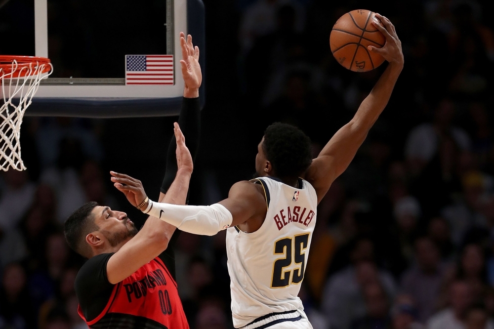 Malik Beasley No. 25 of the Denver Nuggets goes to the basket against Enes Kanter No. 00 of the Portland Trail Blazers in the fourth quarter during Game Two of the Western Conference semifinals of the 2019 NBA Playoffs at the Pepsi Center on Wednesday in Denver, Colorado. — AFP