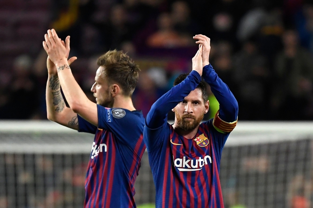 Barcelona's Argentinian forward Lionel Messi (R) and Barcelona's Croatian midfielder Ivan Rakitic celebrate at the end of the UEFA Champions League semifinal first leg football match against Liverpool at the Camp Nou Stadium in Barcelona on Wednesday. — AFP