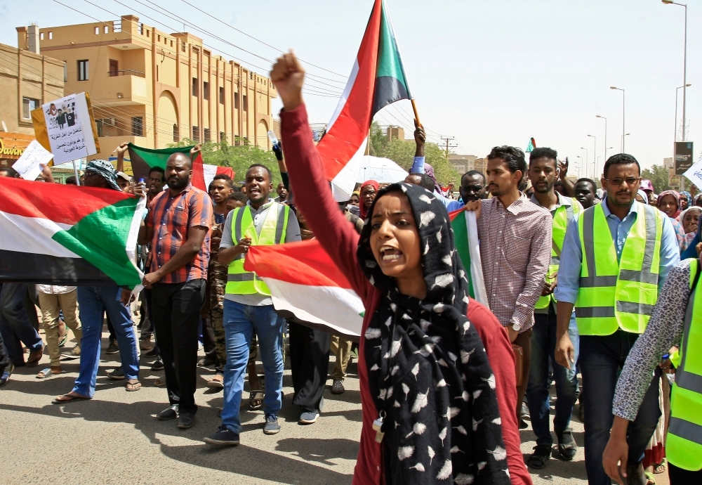 Sudanese chant slogans as they gather during a demonstration outside the army headquarters in Khartoum on Thursday. — AFP