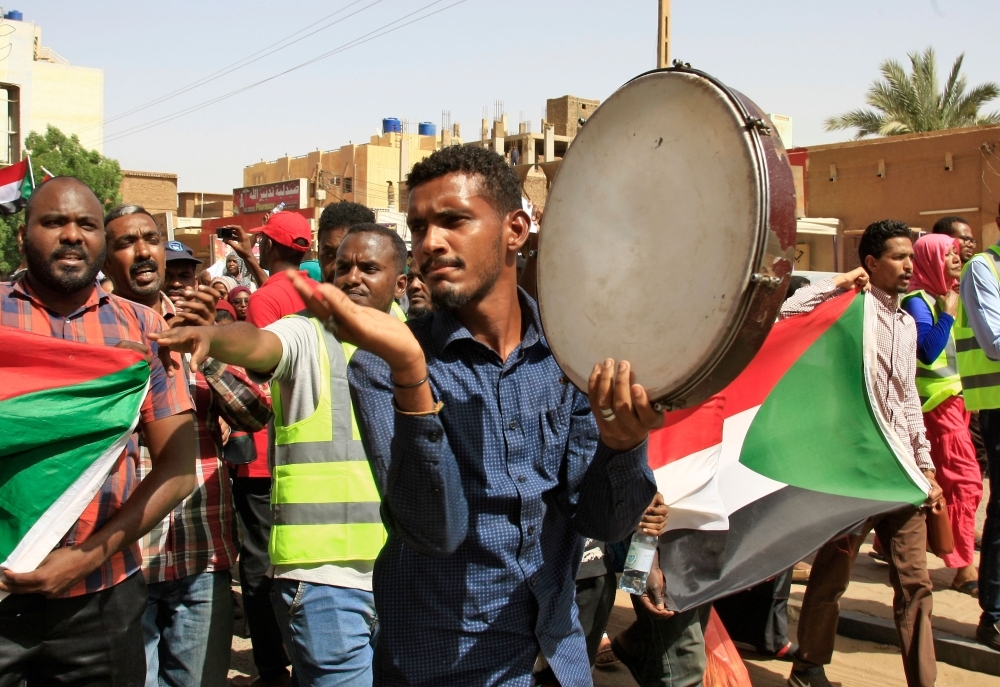 Sudanese chant slogans as they gather during a demonstration outside the army headquarters in Khartoum on Thursday. — AFP