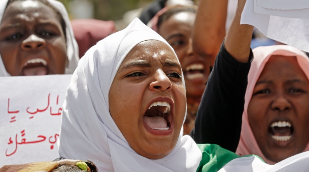 Sudanese chant slogans as they gather during a demonstration outside the army headquarters in Khartoum on Thursday. — AFP