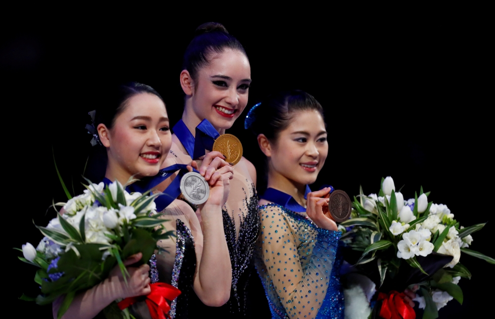 Canada's Kaetlyn Osmond poses with the gold medal as Japan's Wakaba Higuchi and Satoko Miyahara pose with their respective silver and bronze medals after the Ladies Free Skating during the World Figure Skating Championships at the Mediolanum Forum, Milan, Italy, in this file photo. —  Reuters