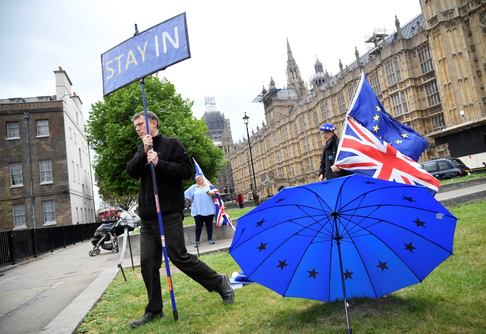 Anti-Brexit protesters are seen near the Houses of Parliament in London on Friday. — Reuters