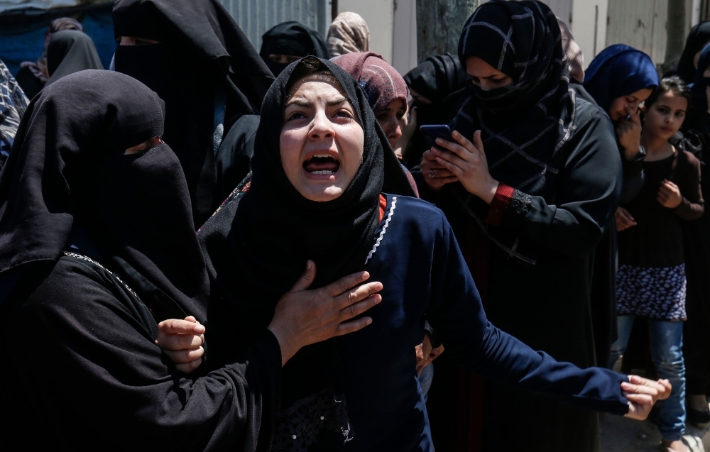 Sawsan, the sister of Palestinian Raed Abu Tair, who was killed during a protest at the Israel-Gaza border fence, mourns during his funeral at Khan Yunis in the southern Gaza Strip on Saturday. — AFP