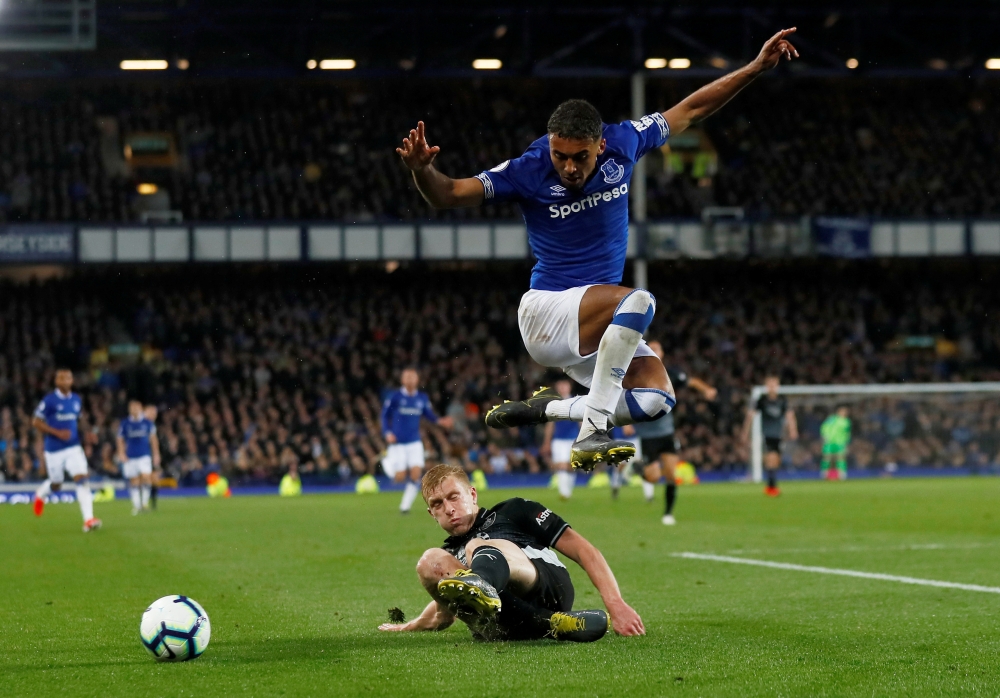 Everton's Dominic Calvert-Lewin in action with Burnley's Ben Mee during the Premier League action at Goodison Park, Liverpool, Britain, on Friday. — Reuters