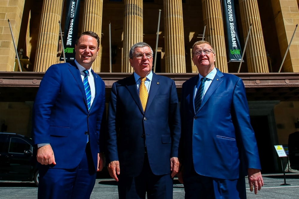 International Olympic Committee (IOC) president Thomas Bach (C) poses for photos with Brisbane Lord Mayor Adrian Schrinner (L) and president of the Australian Olympic Committee John Coates (R) in front of the City Hall in Brisbane on Monday. Brisbane is using a meeting of world sport movers and shakers in the nearby Gold Coast to start pushing a possible bid for the 2032 Summer Olympics. — AFP