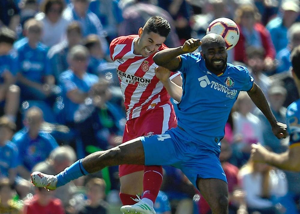 Getafe's French defender Dimitri Foulquier (R) vies with Girona's Spanish defender Juan Pedro Ramirez during the Spanish league football match at the Col. Alfonso Perez stadium in Getafe on Sunday. — AFP