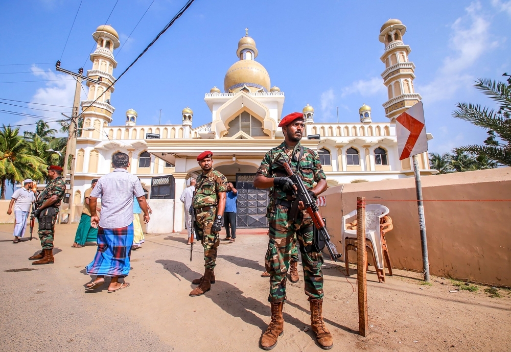 Sri Lankan security personnel stand guard after clashes erupted between Christian and Muslim communities in Negombo. — AFP