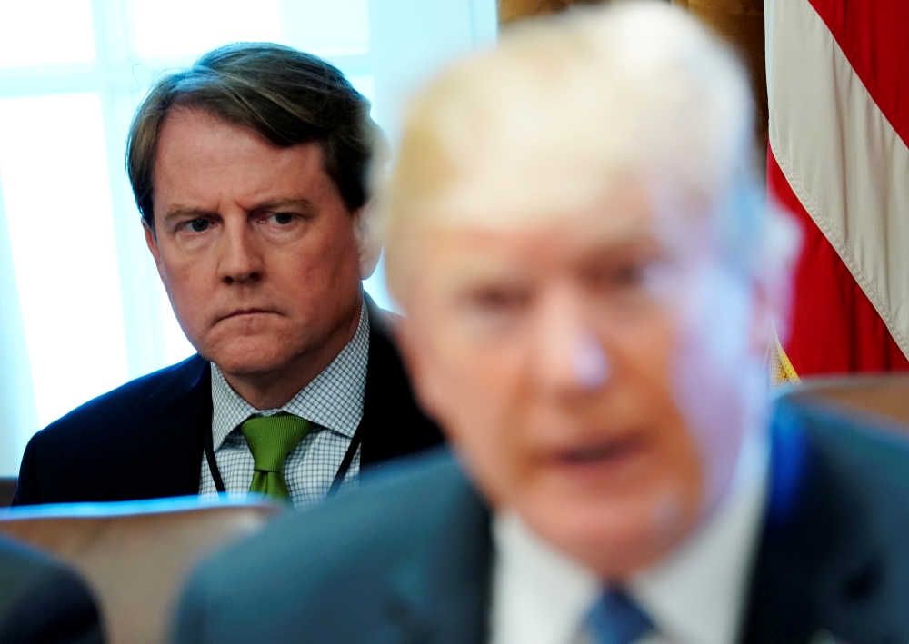  White House Counsel Don McGahn sits behind US President Donald Trump as the president holds a cabinet meeting at the White House in Washington on June 21, 2018.  - Reuters