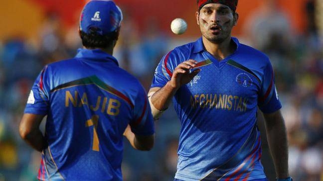 Afghanistan's bowler Hamid Hassan is tossed the ball by teammate Najibullah Zadran during their Cricket World Cup match against Australia in Perth, in this file photo. — Reuters