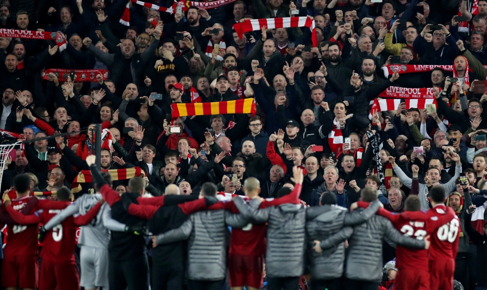 Liverpool players and fans celebrate after the Champions League semifinal second leg match  against Barcelona at Ainfield, Liverpool, on Tuesday. — Reuters