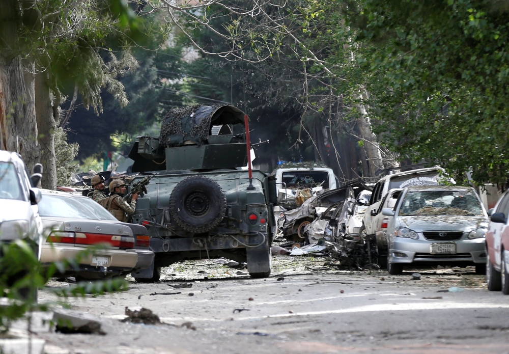 Afghan security forces take position during a gunmen attack in Kabul on Wednesday. — Reuters