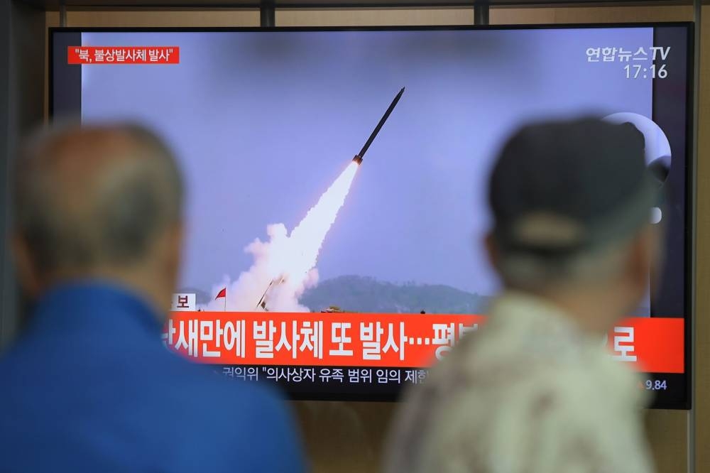 A television showing file footage of North Korean missiles during a South Korean news broadcast at the Seoul Railway Station on Thursday. — AFP