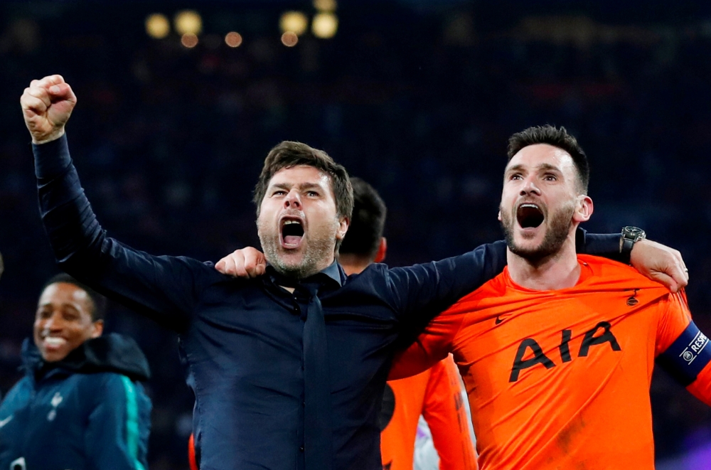 Tottenham manager Mauricio Pochettino and Tottenham's Hugo Lloris celebrate after the match, on Wednesday. — Reuters