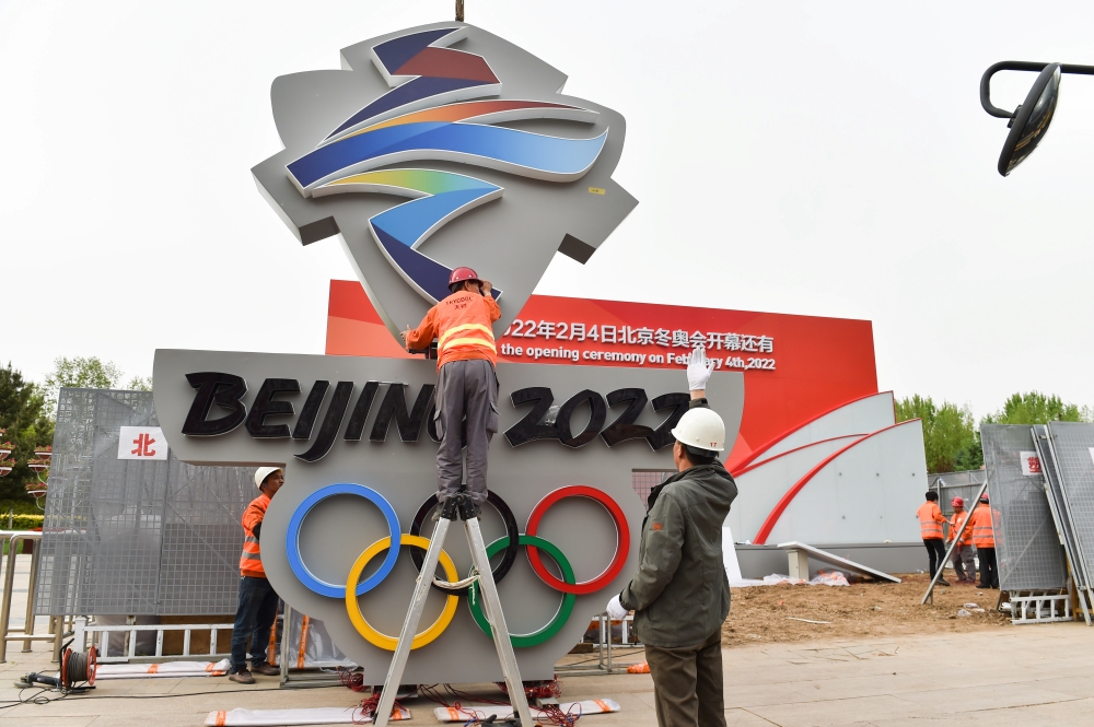Workers install a Beijing 2022 emblem for a countdown clock to mark the number of days till the opening ceremony of the 2022 Winter Olympic Games, in Zhangjiakou, Hebei province, China. — Reuters