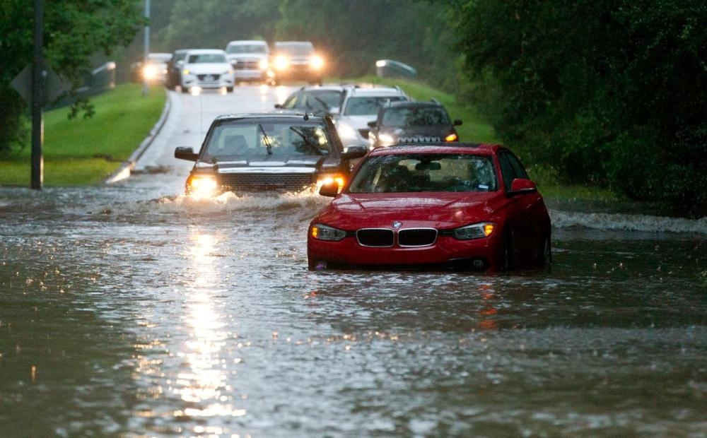 Vehicles enter flooded Kingwood Drive as thunderstorms hit Tuesday in Kingwood, Texas. Heavy rain is battering the Texas coast Friday, flooding highways and downing power lines. — AP