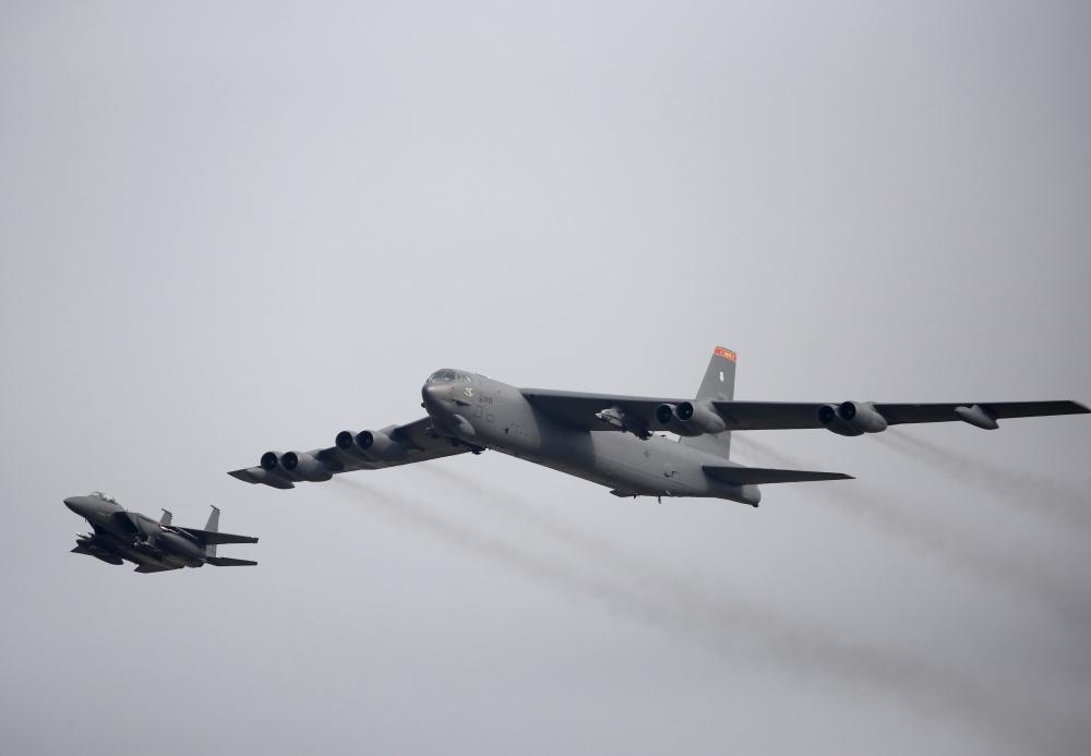 A US Air Force B-52, right, flies over Osan Air Base in Pyeongtaek, South Korea, in this Jan. 10, 2016 file photo. — Reuters