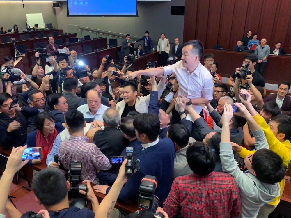 Pro-democracy lawmakers clash with pro-Beijing lawmakers during a meeting for control of a meeting room to consider the controversial extradition bill in Hong Kong on May 11. - Reuters 