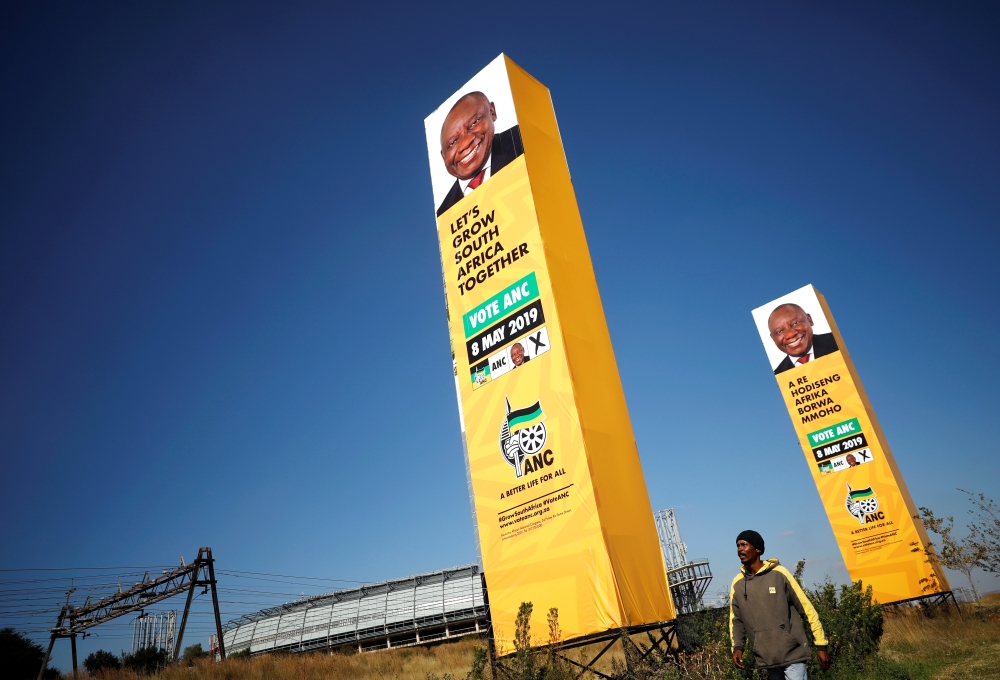 A man walks past election billboards of President Cyril Ramaphosa's ruling African National Congress (ANC) party in Soweto township near Johannesburg, South Africa on May 11. - Reuters